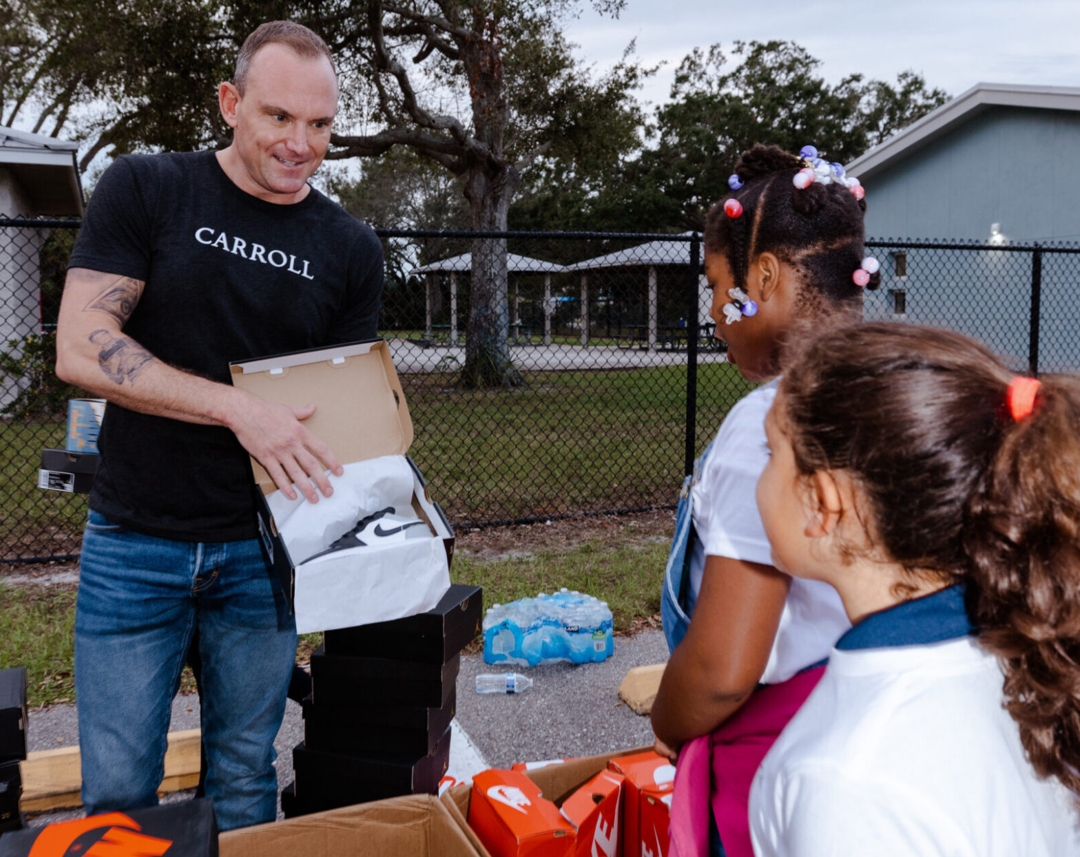 M. Patrick Carroll giving away shoes